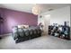 Bedroom with gray carpet, a purple accent wall, and a decorative light fixture at 2918 Rodrick Cir, Orlando, FL 32824