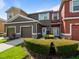 Inviting townhouse exterior with well-maintained landscaping, attached garages, and modern color palettes on a sunny day at 2918 Rodrick Cir, Orlando, FL 32824