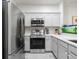 Contemporary kitchen showcasing stainless steel appliances, white cabinets, and a functional layout for easy meal preparation at 2918 Rodrick Cir, Orlando, FL 32824