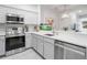 Bright kitchen features stainless steel appliances, white cabinetry, subway tile backsplash, and quartz countertops at 2918 Rodrick Cir, Orlando, FL 32824