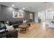 Stylish living room with hardwood floors, elegant decor, and an open layout leading to the dining area and kitchen at 2918 Rodrick Cir, Orlando, FL 32824