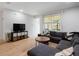 Open-concept living room with natural light, hardwood floors, and a cozy seating arrangement, perfect for relaxation at 2918 Rodrick Cir, Orlando, FL 32824