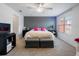 Spacious bedroom with large window, a gray accent wall, ceiling fan, and carpet flooring at 2918 Rodrick Cir, Orlando, FL 32824