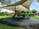 Community playground featuring a covered play structure with slides and climbing features at 2918 Rodrick Cir, Orlando, FL 32824