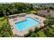 Aerial view of community pool with lounge chairs, umbrellas, and manicured landscaping at 2918 Rodrick Cir, Orlando, FL 32824