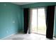 A room with blue walls and sliding glass doors with a view of the outside at 305 E Orange St, Altamonte Springs, FL 32701
