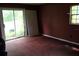 A bedroom with red carpet, sliding glass doors and a view of the outside at 305 E Orange St, Altamonte Springs, FL 32701