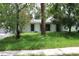 View of single story home with double paned windows and overgrown yard at 305 E Orange St, Altamonte Springs, FL 32701