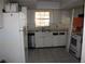 View of kitchen with white appliances and tile floors at 305 E Orange St, Altamonte Springs, FL 32701