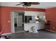 Open floor plan to kitchen featuring salmon colored walls and ceiling fan at 305 E Orange St, Altamonte Springs, FL 32701