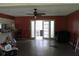Salmon colored living room with ceiling fan and access to kitchen and outdoors at 305 E Orange St, Altamonte Springs, FL 32701