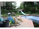 In-ground pool in backyard with slide and diving board at 305 E Orange St, Altamonte Springs, FL 32701