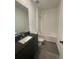 Clean bathroom featuring black granite vanity, and a bright white shower-tub combo at 3213 Energy Dr, Kissimmee, FL 34747