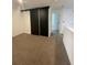View of carpeted bedroom with a closet behind black sliding doors at 3213 Energy Dr, Kissimmee, FL 34747