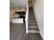 The kitchen is open to a staircase with modern finishes, making a great space to entertain at 3213 Energy Dr, Kissimmee, FL 34747