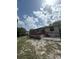 A rear view of the home showcasing a spacious wooden back deck at 34008 S Haines Creek Rd, Leesburg, FL 34788