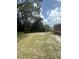 An additional view of the backyard featuring mature trees and a partial view of the back deck at 34008 S Haines Creek Rd, Leesburg, FL 34788