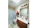 Bathroom with a skylight, floral wallpaper, and a seashell-themed shower curtain at 34008 S Haines Creek Rd, Leesburg, FL 34788