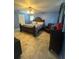 Primary bedroom with a ceiling fan, tile floors, and dark wood furniture at 34008 S Haines Creek Rd, Leesburg, FL 34788