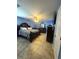 Primary bedroom with a ceiling fan, tile floors, and dark wood furniture at 34008 S Haines Creek Rd, Leesburg, FL 34788