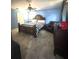 Primary bedroom with a ceiling fan, tile floors, and dark wood furniture at 34008 S Haines Creek Rd, Leesburg, FL 34788