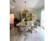 Bright dining room featuring a unique light fixture, built in shelving, and sliding glass doors at 34008 S Haines Creek Rd, Leesburg, FL 34788