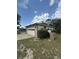 Front of the home with a two-car garage and a driveway at 34008 S Haines Creek Rd, Leesburg, FL 34788