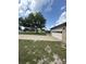 A partial view of the front lawn and a two car garage at 34008 S Haines Creek Rd, Leesburg, FL 34788