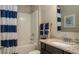 Bright bathroom with a shower and bathtub combo, a granite vanity, and nautical decor at 345 S Sunset Ave, Mascotte, FL 34753