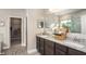 Elegant bathroom with dual sinks, granite countertops, and a walk-in shower at 345 S Sunset Ave, Mascotte, FL 34753