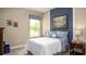 Comfortable bedroom with blue accents, a baseball theme, and natural light at 345 S Sunset Ave, Mascotte, FL 34753