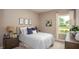 Cozy bedroom with a comfortable bed, soft lighting, and a view of the outdoors at 345 S Sunset Ave, Mascotte, FL 34753