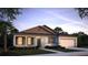 Charming single-story home featuring a two-car garage, neutral color palette and well-maintained landscaping at 345 S Sunset Ave, Mascotte, FL 34753