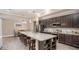 Beautiful kitchen with a large granite island, stainless steel appliances, and dark wood cabinetry at 345 S Sunset Ave, Mascotte, FL 34753