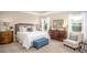 Serene main bedroom with neutral tones, plush carpet, and large windows at 345 S Sunset Ave, Mascotte, FL 34753
