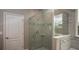 Modern bathroom showcasing a glass-enclosed shower with stylish tile and sleek fixtures at 345 S Sunset Ave, Mascotte, FL 34753