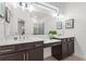 Bright bathroom featuring double sinks, a large mirror, and a vanity area with ample storage at 363 Miro Dr, Davenport, FL 33837