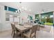 Open concept dining area flows into the living room with a modern chandelier and a sliding glass door to the backyard at 363 Miro Dr, Davenport, FL 33837