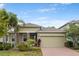 Charming single-story home boasts stone accents, lush landscaping, and a brick driveway for added curb appeal at 363 Miro Dr, Davenport, FL 33837
