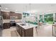 Modern kitchen showcasing a large island, stainless steel appliances, and seamless flow into the inviting living area at 363 Miro Dr, Davenport, FL 33837