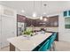 Stylish kitchen with a spacious island, seating, stainless steel appliances, and ample cabinet space for storage at 363 Miro Dr, Davenport, FL 33837