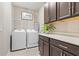 Convenient laundry room with modern washer and dryer, cabinetry, and counter space at 363 Miro Dr, Davenport, FL 33837