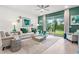 Well-lit living room showcasing sliding doors to the backyard, chic decor, and comfortable seating at 363 Miro Dr, Davenport, FL 33837