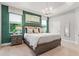 Beautifully decorated main bedroom featuring an accent wall, large windows, and a neutral color palette at 363 Miro Dr, Davenport, FL 33837