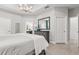 Serene main bedroom with tray ceiling, neutral walls, tile floors, and ensuite bathroom access at 363 Miro Dr, Davenport, FL 33837