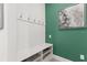 Functional mudroom entry with hooks, bench seating, and storage for shoes and accessories at 363 Miro Dr, Davenport, FL 33837