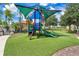 Colorful playground area with a slide, climbing structure, and soft turf, surrounded by trees at 363 Miro Dr, Davenport, FL 33837