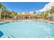Resort-style pool with ample lounge seating and stunning views of the meticulously landscaped community and palm trees at 363 Miro Dr, Davenport, FL 33837