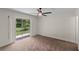 Bedroom with ceiling fan, neutral carpet, sliding glass doors, and backyard view at 369 Placid Lake Dr, Sanford, FL 32773