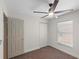 Bedroom with ceiling fan, neutral carpet, window, and closet at 369 Placid Lake Dr, Sanford, FL 32773